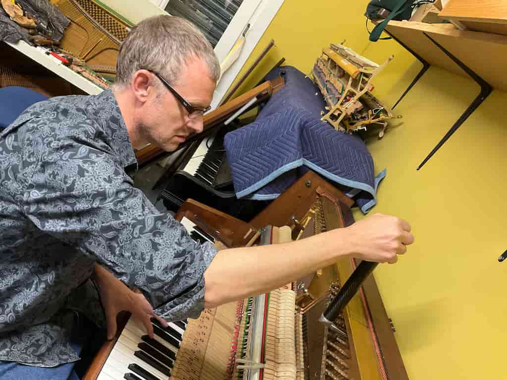Nick tuning an upright piano