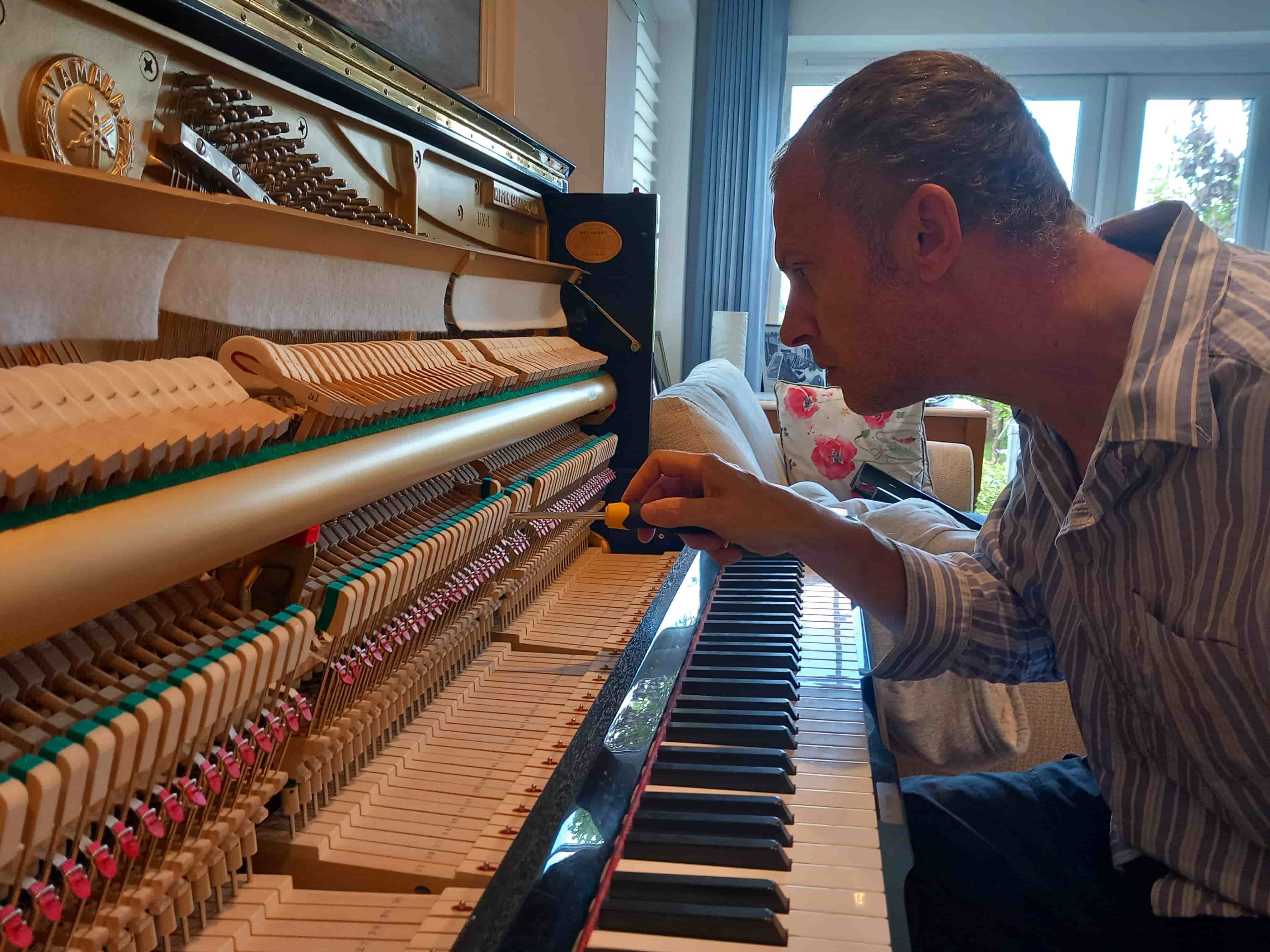 Nick tuning an upright piano